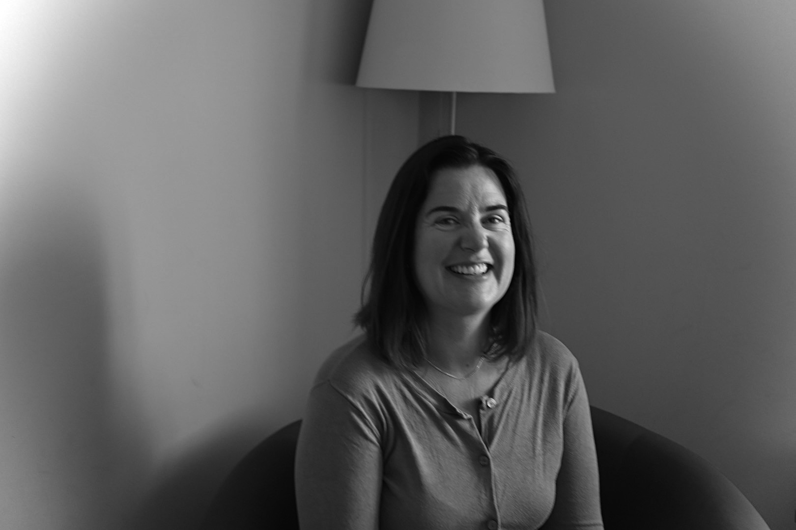 Lucy, a child and young person counsellor, smiling warmly in a calm therapy room